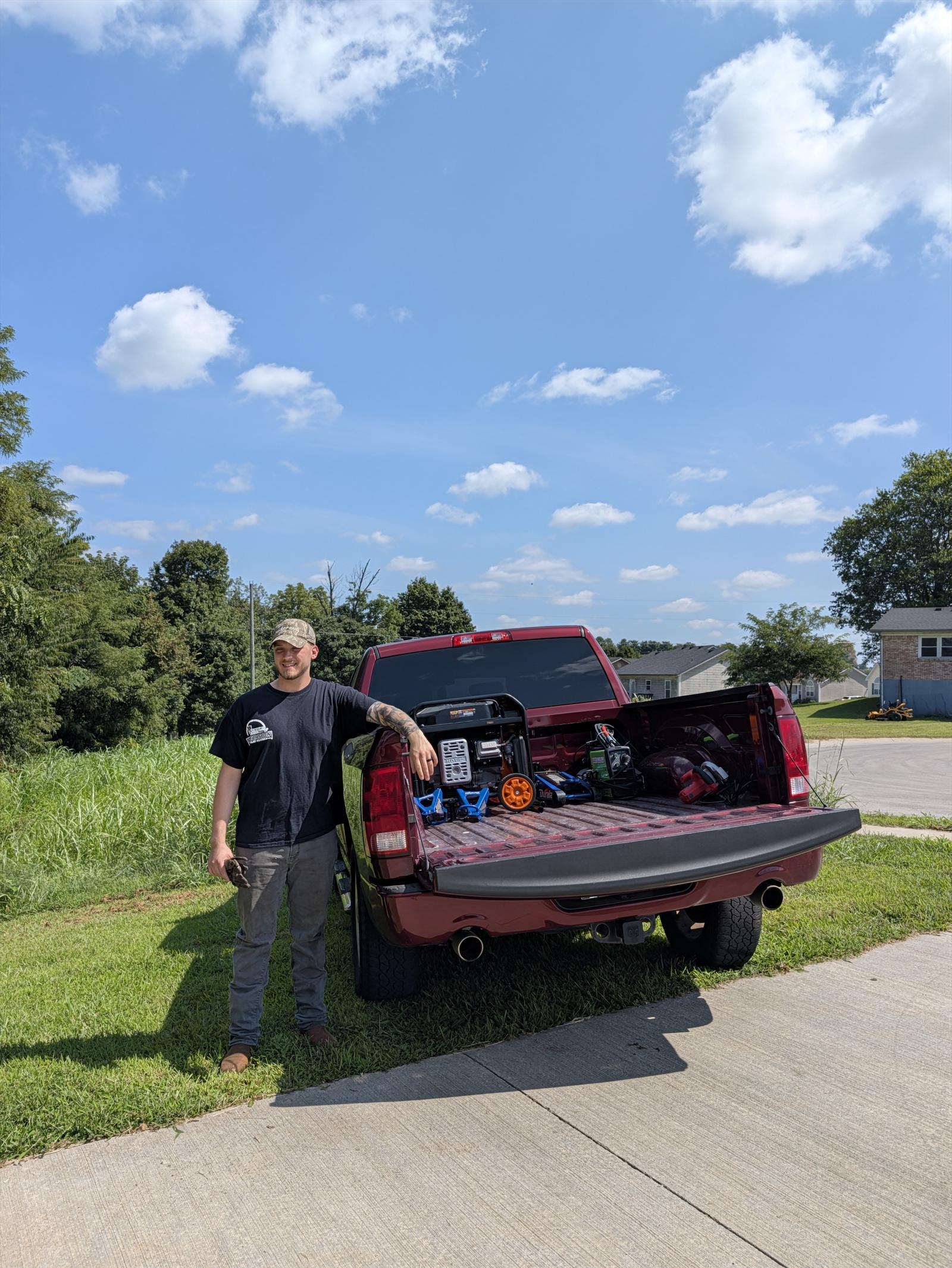 Owner of Precision Trailer Solutions standing at his service truck